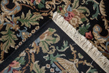 Vintage Indian Savonnerie rug detail: hand-knotted reverse, ornate Rococo pattern in black, green, beige, blue.