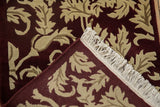 The rug's corner folded to display the full pile, secure ivory fringe, and hand-knotted back.