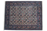 Vintage Pakistani Savonnerie carpet with an ivory floral lattice pattern on a dark navy blue field.