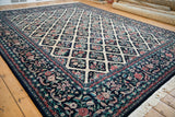 Angled view of a vintage Pakistani Savonnerie carpet, showing the full scale of its floral lattice pattern.