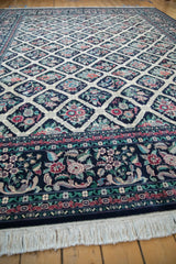 Corner view of a Pakistani Savonnerie carpet, showing its floral border and ivory fringe.