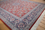 Vintage Pakistani Kashan rug with cherry red floral vinery, navy border, and ivory fringe.