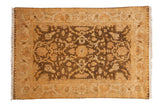 Vintage Indian Oushak rug with a central medallion and floral patterns in gold, saffron, and dusty olive green.