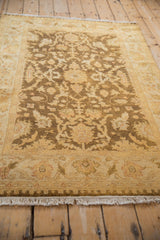 Angled view of a vintage Oushak rug highlighting its plush, lustrous wool pile and golden tones.