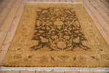 A vintage Indian Oushak rug seen from an angle, highlighting its soft, high-luster wool pile.