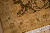 Corner detail of the vintage Oushak rug showing its soft, lustrous, full wool pile and intact fringe.