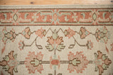 Ivory field with copper and sea foam green floral palmettes on Soumac Mahal rug.