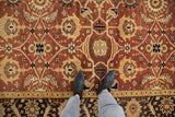 Alternating Samovar and leaf designs on the copper and gold field of a vintage Indian Mahal carpet.