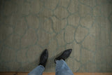 Abstract Indian carpet, dusty celadon green fieldstone pattern, and abrashed pile.