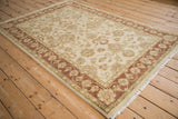 Traditional hand knotted Indian Mahal rug with cream floral field and copper vine border.
