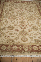 Indian Mahal rug's cream field: floral cross-sections, scrolling vines, copper and beige border.