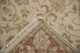 Vintage Indian Mahal rug's cream pile, copper floral motifs, and neatly woven hand-knotted back.
