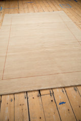 Subtle beige abrashes across the open field with a black cherry red dashed border.