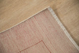 Indian Gabbeh hand-knotted rug corner with beige pile, red-threaded foundation, intact selvage.