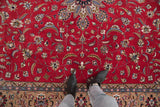 Cherry red Pakistani Isfahan design rug with intricate scrolling vinery and patterned beige border.