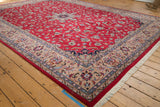 Vintage Pakistani Isfahan carpet: cherry red field of delicate vinery, beige floral borders.