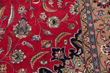 Vintage Isfahan rug: intricate cherry red field with vinery, palmettes, and beige border.