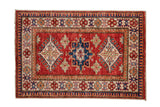 Pakistani Caucasian rug mat with cherry red abrashed ground and geometric medallions.