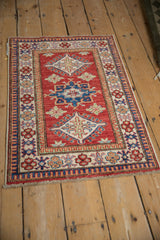 Cherry red Pakistani Caucasian rug displaying geometric hook and latch motifs.
