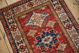 Pakistani Caucasian design rug border with sapphire blue geometric shapes and cream floral patterns.