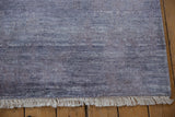Cream fringe on modern abstract rug, highlighting dusty royal and pale denim blue striations.