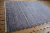 Faux silk pile with horizontal blue abrashes on a modern abstract Indian carpet.