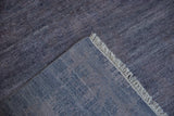 Dusty blue pile with abrashes, creamy fringe, and hand-knotted foundation of the Modern Abstract rug.