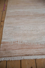 Ivory fringe and striated faux silk pile in sand and copper tones on the modern abstract rug.