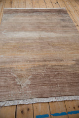 Faux silk pile with varying striation density and shading in sand, ivory, copper.
