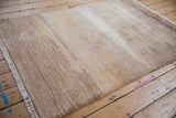 Faux silk pile of the Modern Abstract rug with ivory, sand, and copper striations.