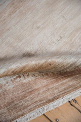 Modern Abstract rug's striated pile, featuring ivory, sand, copper tones, and cream fringe.