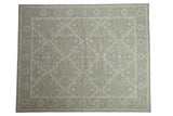 Contemporary Indian Soumac rug: pale sage green, silver, and beige floral trellis pattern.