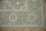 Contemporary Indian Soumac carpet corner with sage green field, beige floral trellis, Herati border.