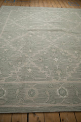 Pale sage green Indian Soumac carpet with Herati-inspired border and trellis vinery.