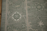 Contemporary Indian Soumac weave, showing pale sage green quatrefoil blossom and side cord selvage.