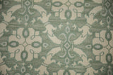 Close-up of pale jade and ivory roundel Soumac pattern, showing dimensional pile.