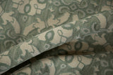 Textured ivory and celadon green Soumac carpet's unique piled and flatweave pattern.