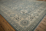 Corner detail of Indian Mahal rug showing ivory boteh border and slate blue floral field.