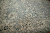 Indian Mahal carpet's abrashed slate blue floral field and repeating boteh border.