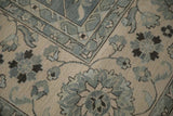Indian Mahal carpet: oversize floral cross-sections, scrolled leaves, border in shades of blue and ivory.
