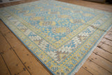 Pakistani Ersari rug corner with vivid blue, yellow, ivory guls, geometric border, and blue selvage.