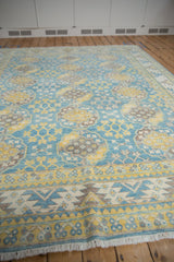 Pakistani Ersari carpet with vivid blue, yellow, ivory, brown gul motifs and geometric border.
