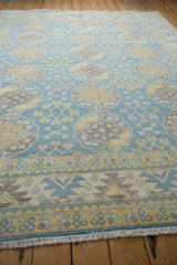 Pakistani Ersari carpet border and repeating snowflake-contour guls in vivid blue, yellow, ivory, coffee brown.