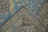 Folded corner of Pakistani Ersari carpet, vivid blue, yellow snowflake pattern, foundation, and fringe.