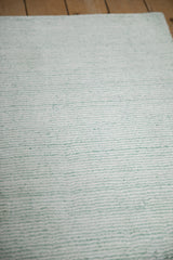Lustrous, soft striations of sea foam green blue and ivory platinum.
