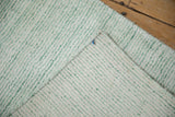 Hand-knotted backing and soft striated pile of the sea foam green and ivory abstract rug.