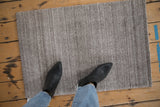 Hand knotted Indian Abstract rug mat with silver, charcoal striations and abrashes.