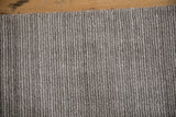 Hand-knotted pile texture with silver, platinum, charcoal abstract striations.