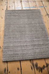 Silver, platinum, and charcoal striated pile on a modern abstract Indian rug.