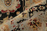 Folded view of the plush wool pile showing cherry red and saffron floral details.
